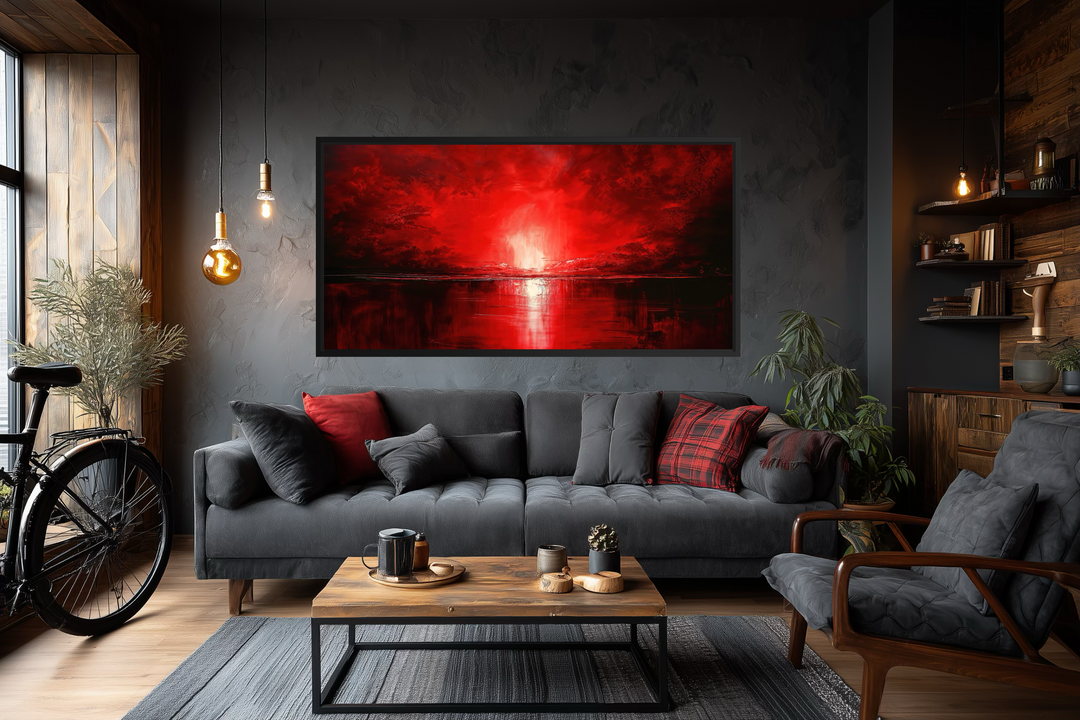 Red Ocean Sunset Framed Canvas Wall Art displayed in a modern, dark-toned living room.