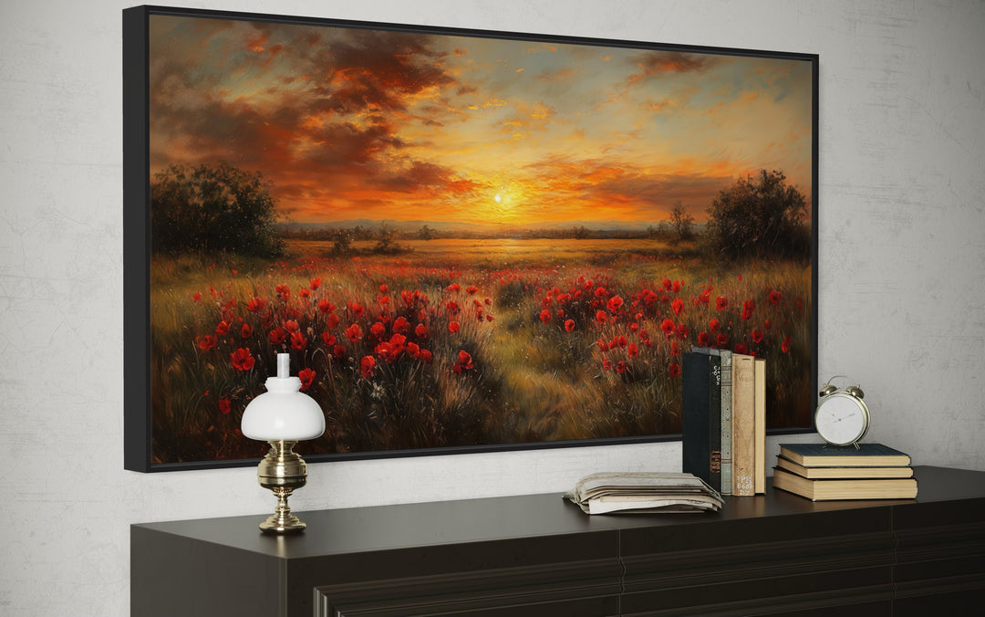 Panoramic canvas wall art of a red poppy field under a golden sunset glow in a black frame.