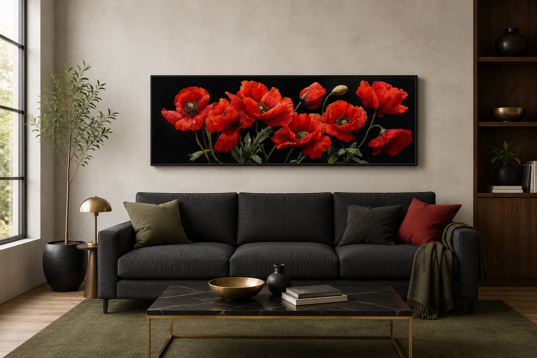 Long horizontal framed canvas wall art featuring red poppies on a black background above a sofa.