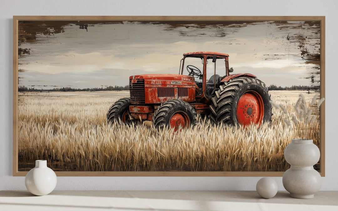 Framed rustic farmhouse wall art of a vintage red tractor in a golden wheat field.