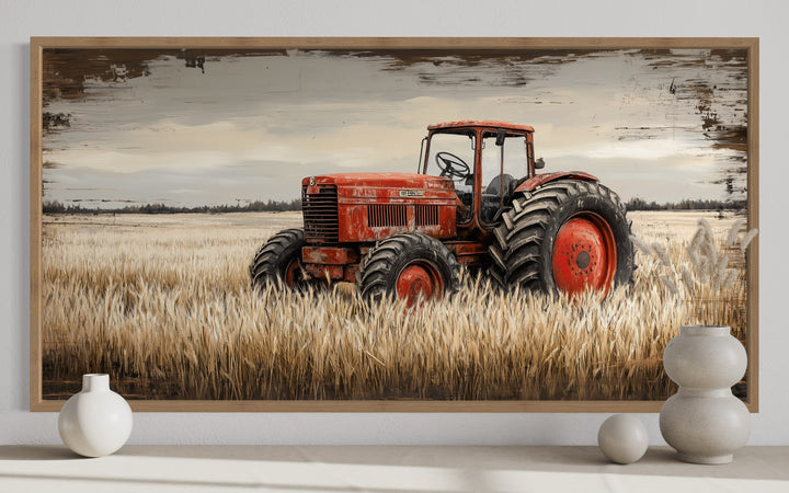 Framed rustic farmhouse wall art of a vintage red tractor in a golden wheat field.