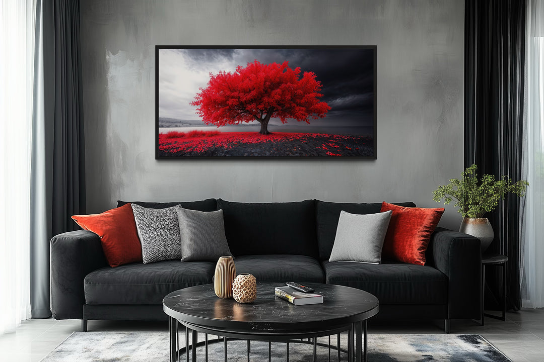 Framed canvas print of a vibrant red tree against a monochrome landscape in a modern living room.
