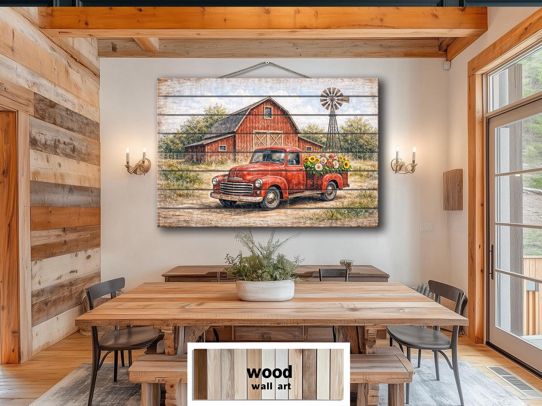Red truck with flowers and barn distressed wood wall art hanging in a farmhouse dining room.