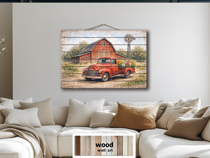 Red truck with flowers and barn farmhouse wall art printed on a horizontal wood plank panel.