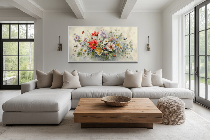 Red wildflowers bouquet watercolor botanical framed canvas wall art above a sofa in a living room.