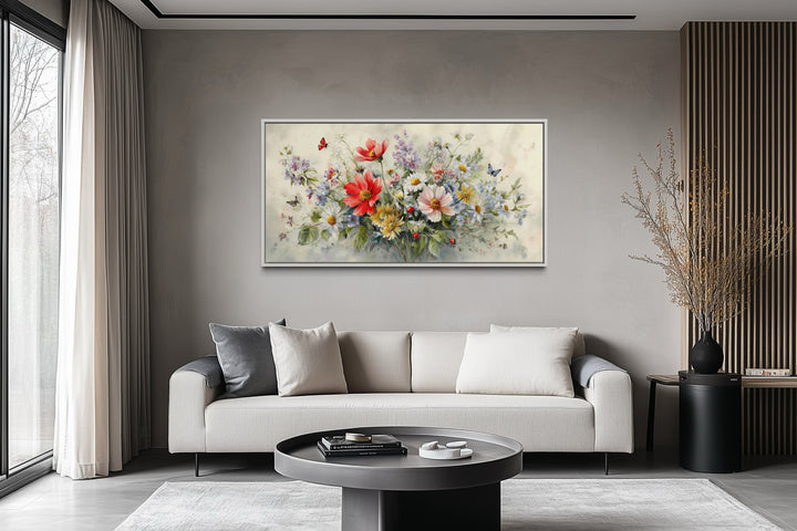 Red wildflowers bouquet watercolor botanical framed canvas wall art above a modern sofa.