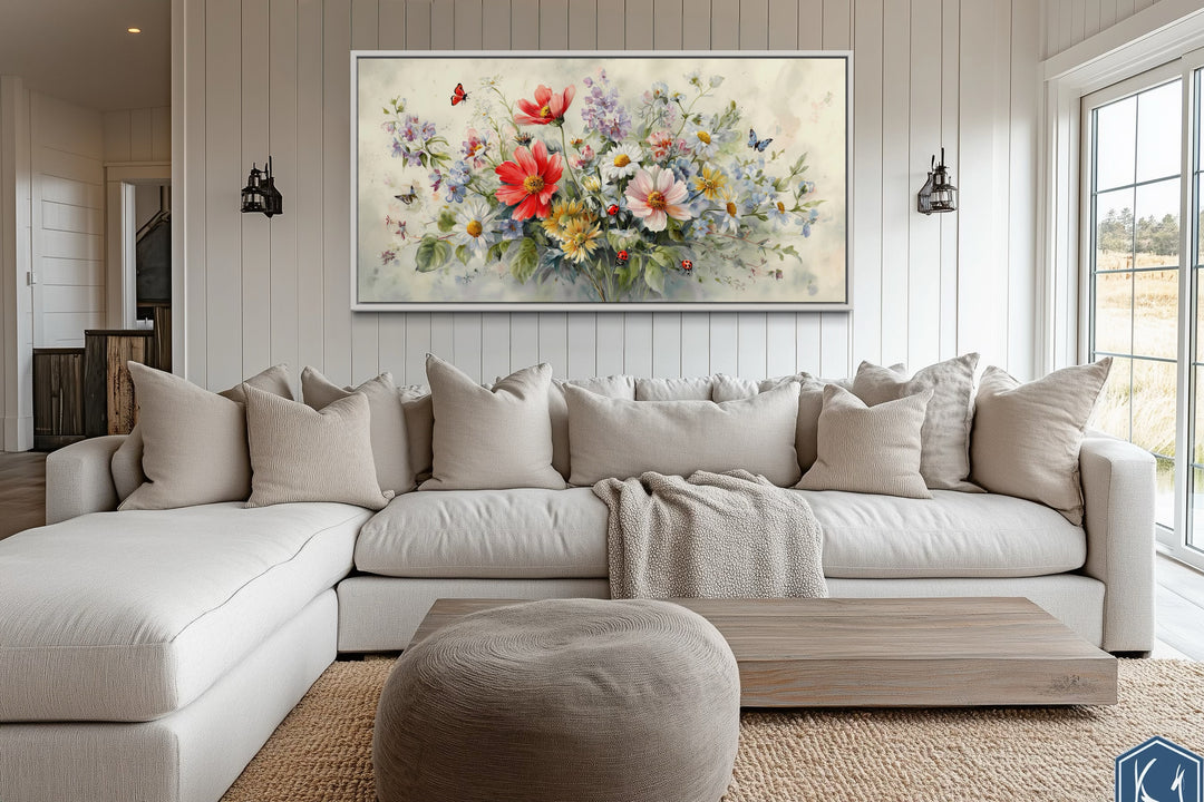 Red wildflowers bouquet watercolor botanical framed canvas wall art above a neutral sectional sofa.