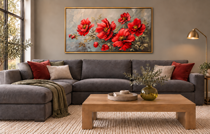 Red abstract flowers framed canvas wall art hanging above a gray sofa in a modern living room.