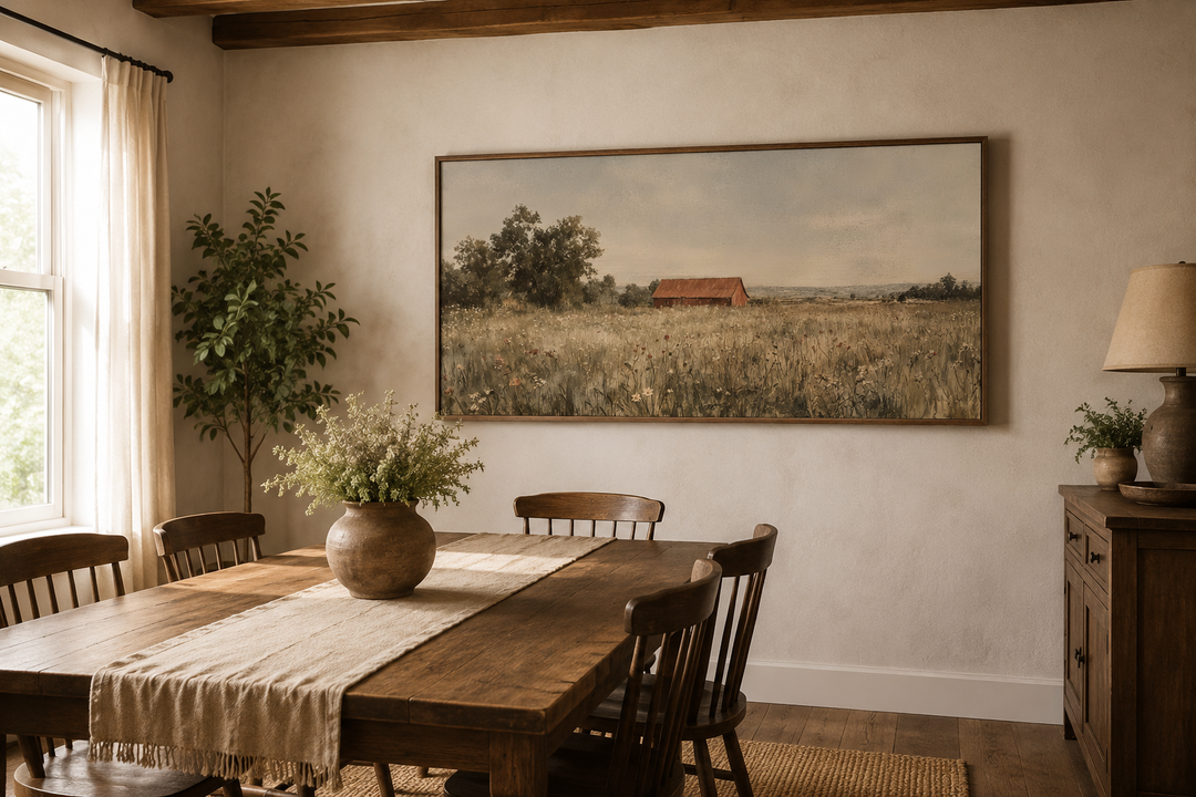 Red barn in wildflower field neutral country farmhouse wall art in a rustic dining room.