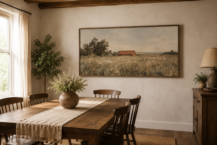 Red barn in wildflower field neutral country farmhouse wall art in a rustic dining room.