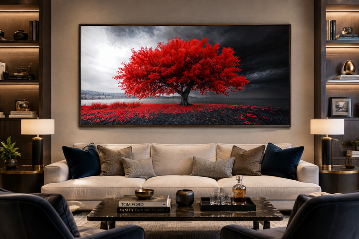 Framed canvas print of a vibrant red tree against a monochrome landscape in a modern living room.