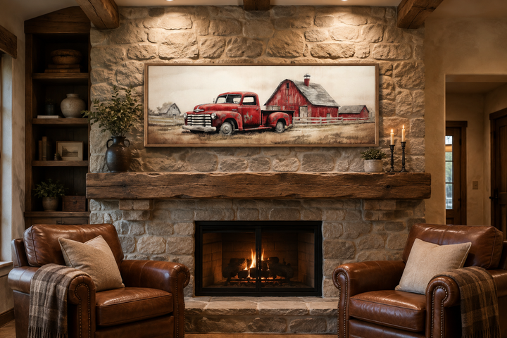 Red truck and barn painting on wood framed canvas wall art hanging above a stone fireplace mantel.