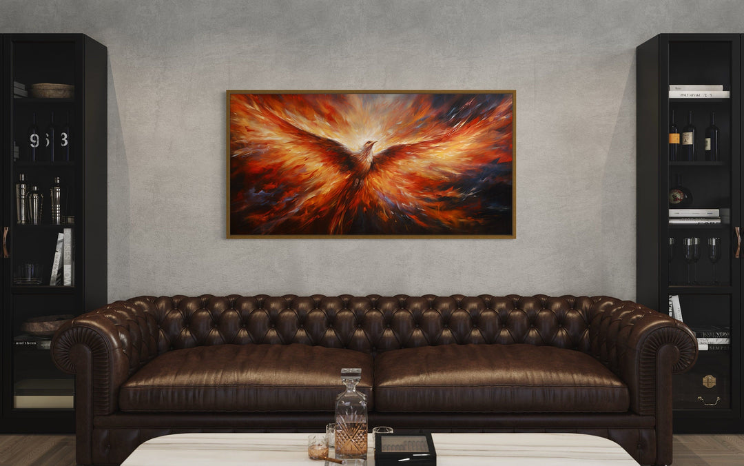 Rising Phoenix extra large orange framed canvas wall art above a brown leather sofa.