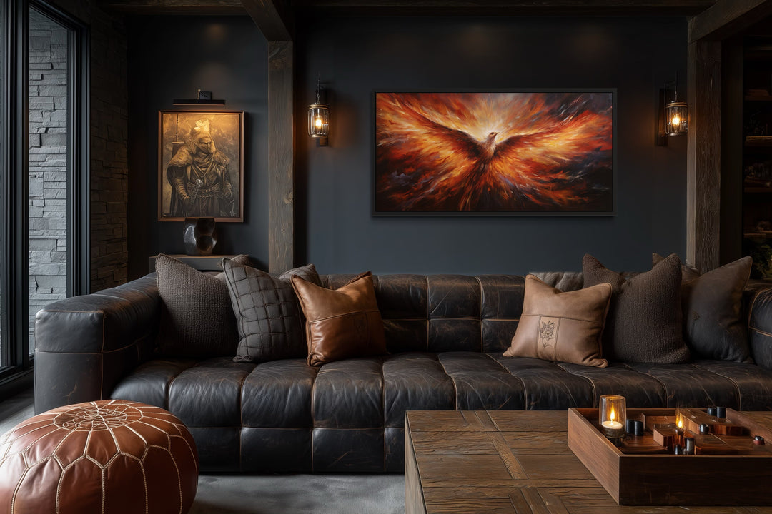 Extra large framed canvas wall art of a fiery orange phoenix rising above a dark leather sofa.