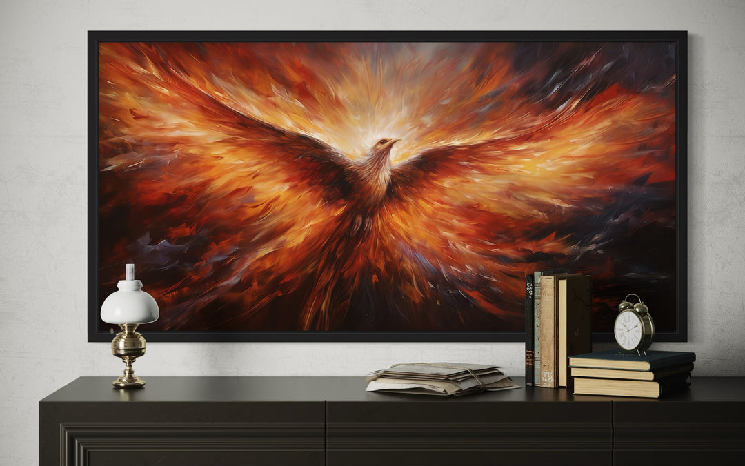 Extra large framed canvas wall art of a fiery orange phoenix rising from flames above a dark dresser.