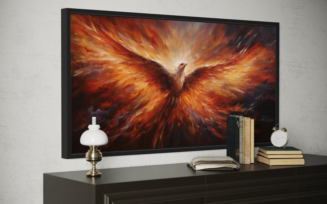 Extra large framed canvas wall art of a fiery orange phoenix rising from flames above a dresser.