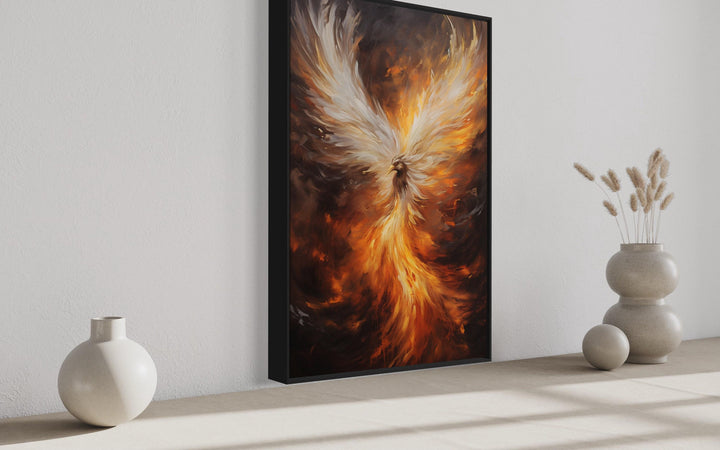 Rising Phoenix framed canvas wall art with fiery orange and white wings in a vertical black frame.