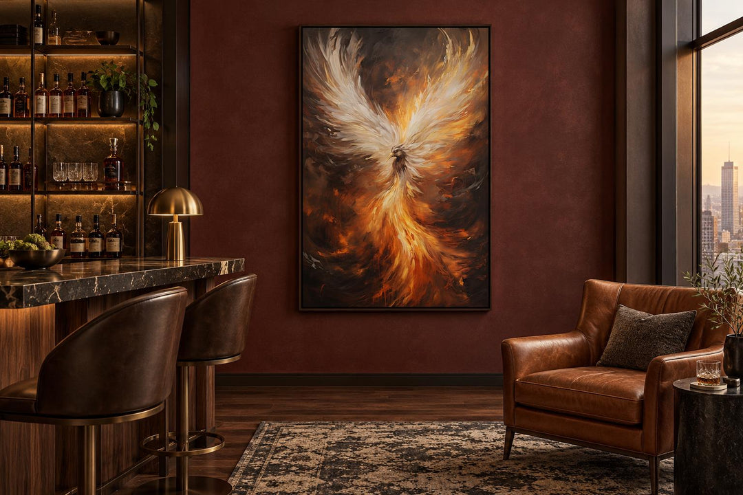 Rising phoenix framed canvas wall art in a dark room with a leather chair and bar.