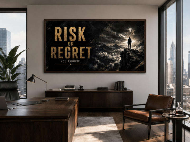 Risk or Regret quote motivational wall art in a dark, modern office with a wooden desk and chair.