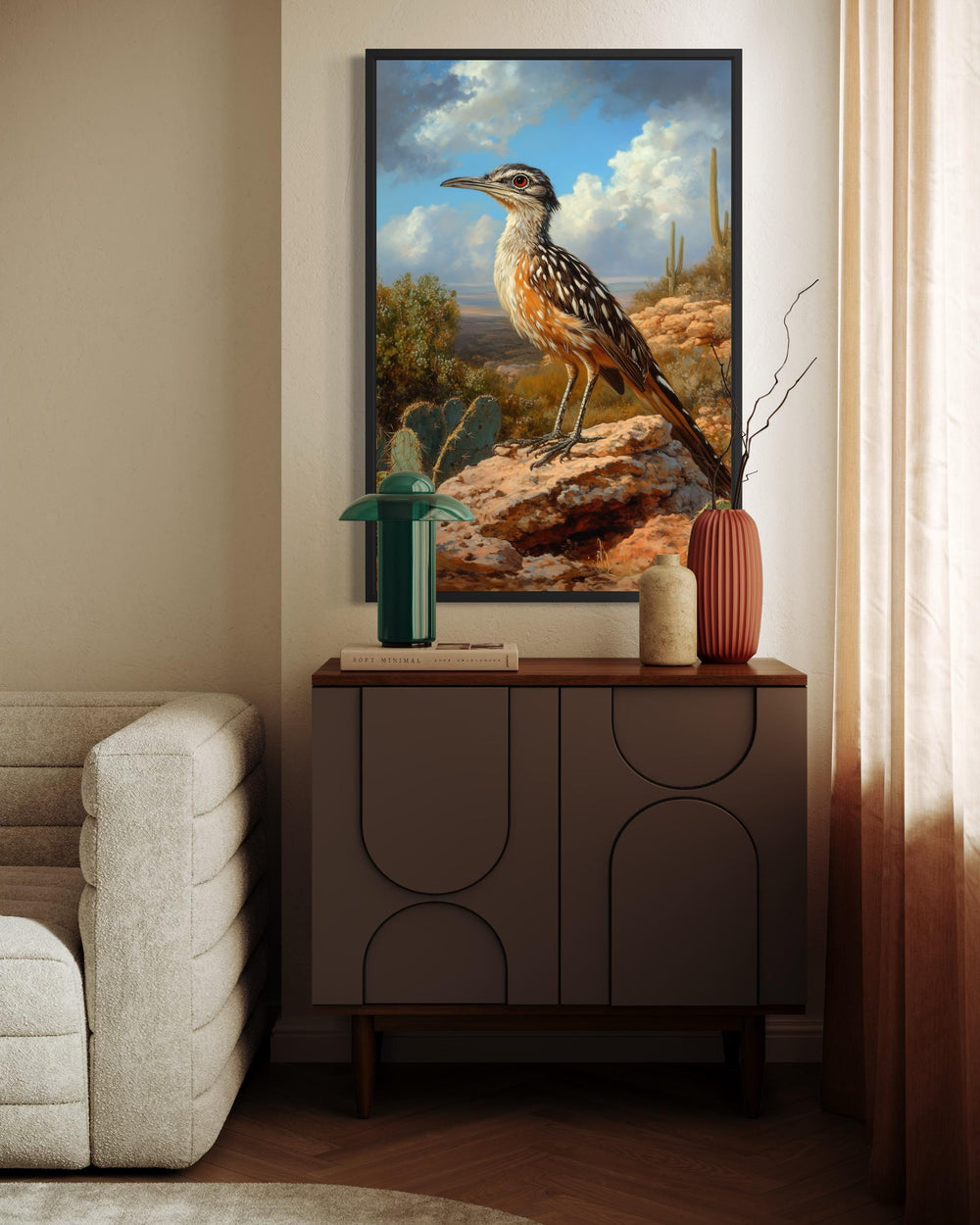 A framed canvas print of a roadrunner perched on a desert rock in a modern living room setting.