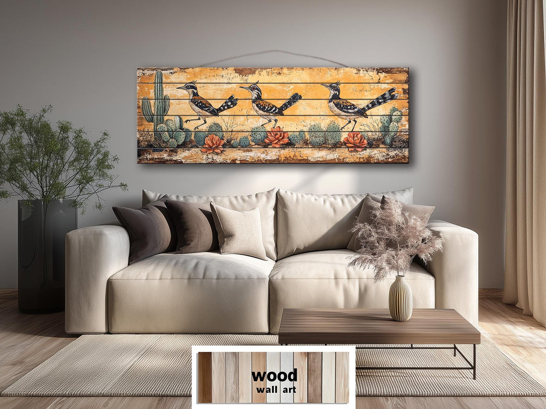 Horizontal wood wall art featuring three roadrunners and cacti in a distressed desert scene.
