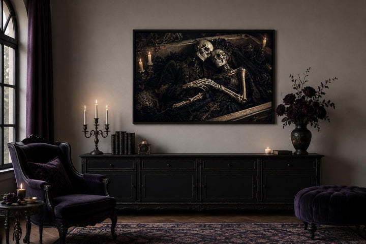 Romantic gothic canvas art of two skeletons embracing in an ornate coffin above a black sideboard.