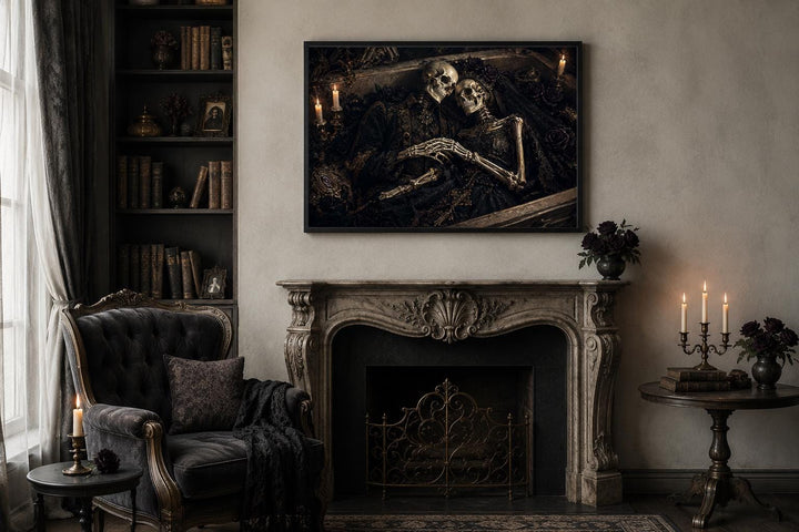 Gothic canvas art of an embracing skeleton couple in a coffin, hung above a classic fireplace.