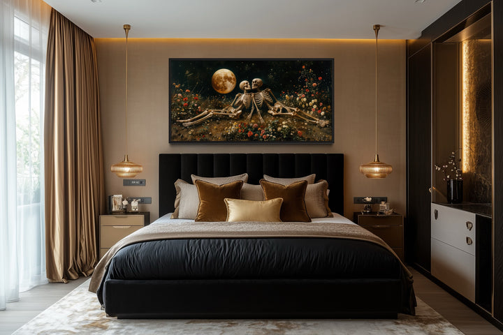 Gothic wall art of two skeletons in a flower meadow under a full moon above a black bed.