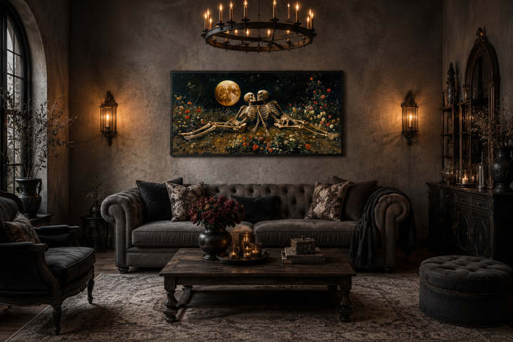 Gothic wall art of two skeletons in a flower meadow under a full moon above a dark sofa.
