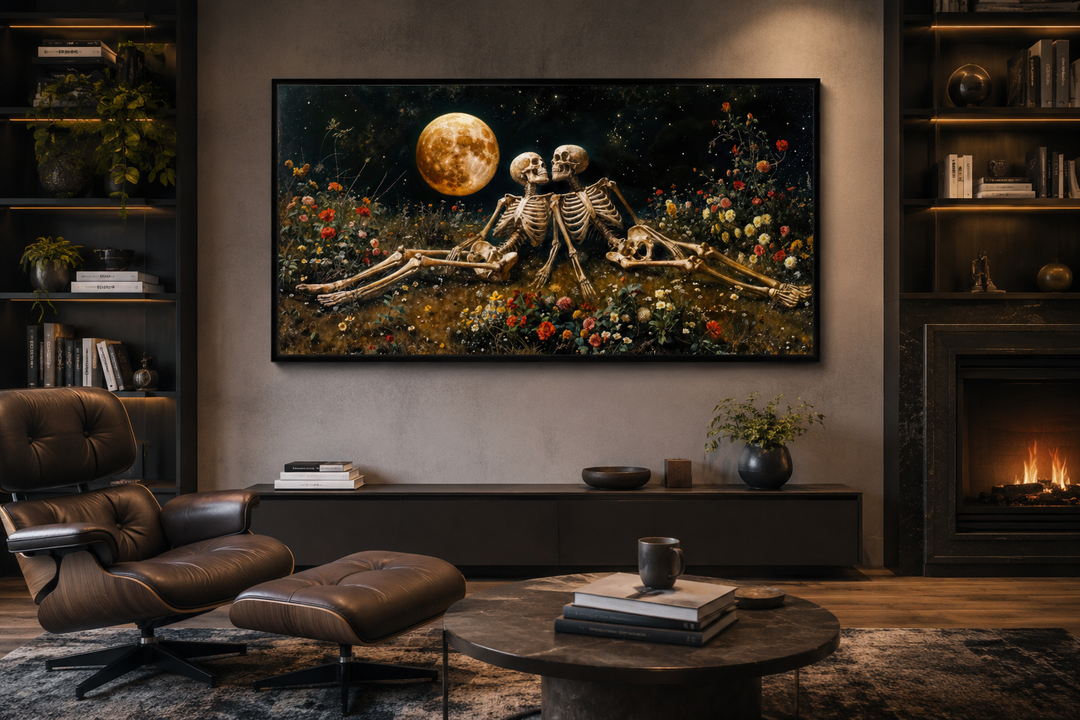 Gothic wall art of two skeletons in a flower meadow under a full moon, framed above a dark console.