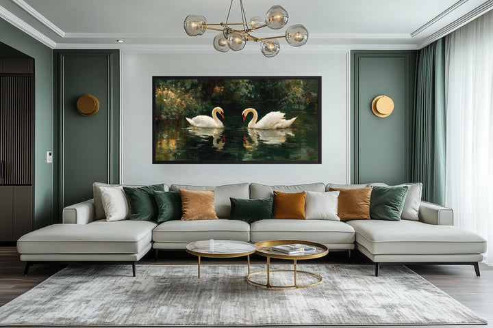 Romantic swans couple in the lake canvas wall art displayed above a modern sofa in a living room.