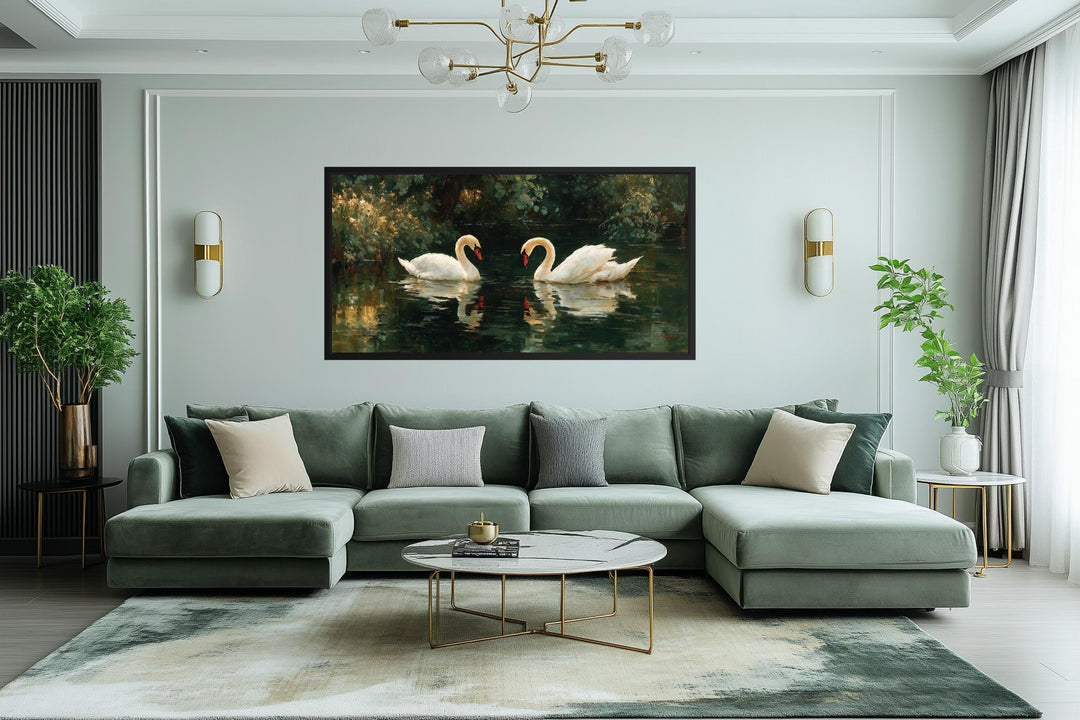 Romantic swans couple in the lake canvas wall art displayed above a modern green sectional sofa.