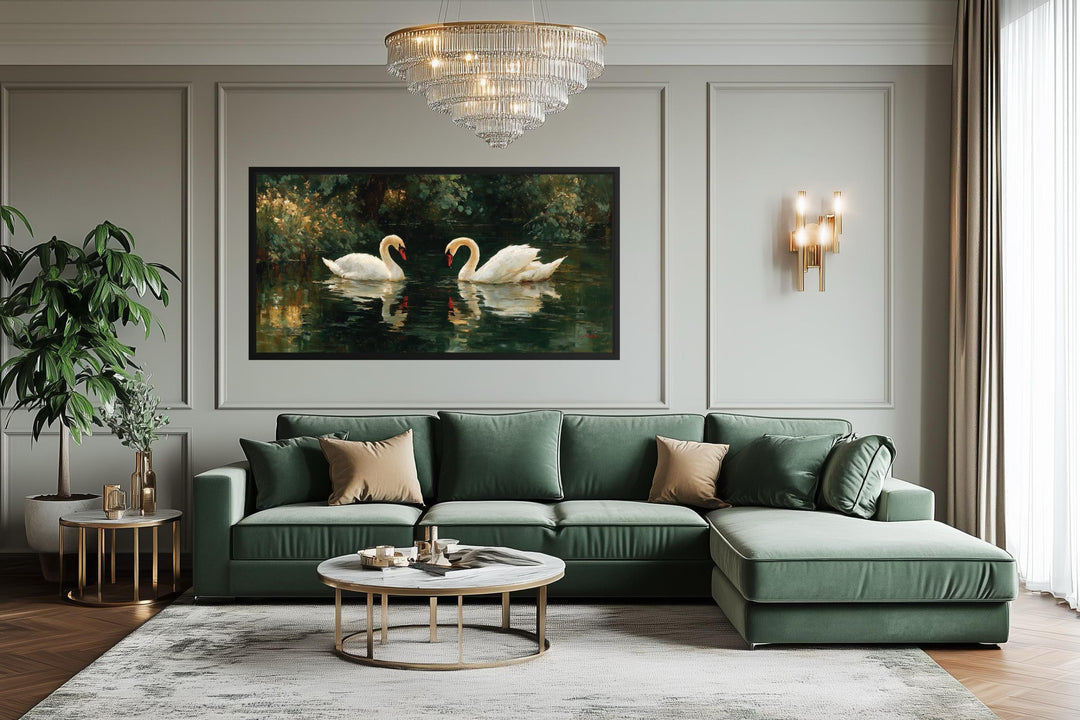 A horizontal canvas wall art of two white swans on a dark lake hangs in a modern green living room.