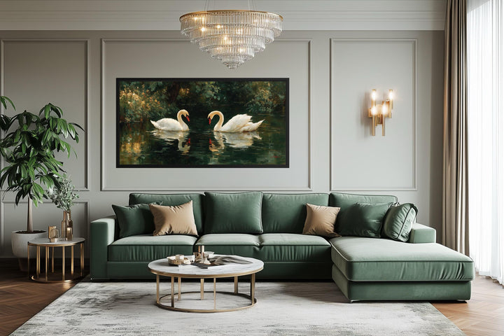 A horizontal canvas wall art of two white swans on a dark lake hangs in a modern green living room.