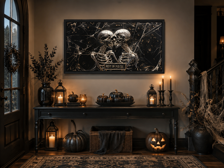 Framed gothic wall art of two skeletons with a "Rest In Pieces" plaque in a Halloween entryway.