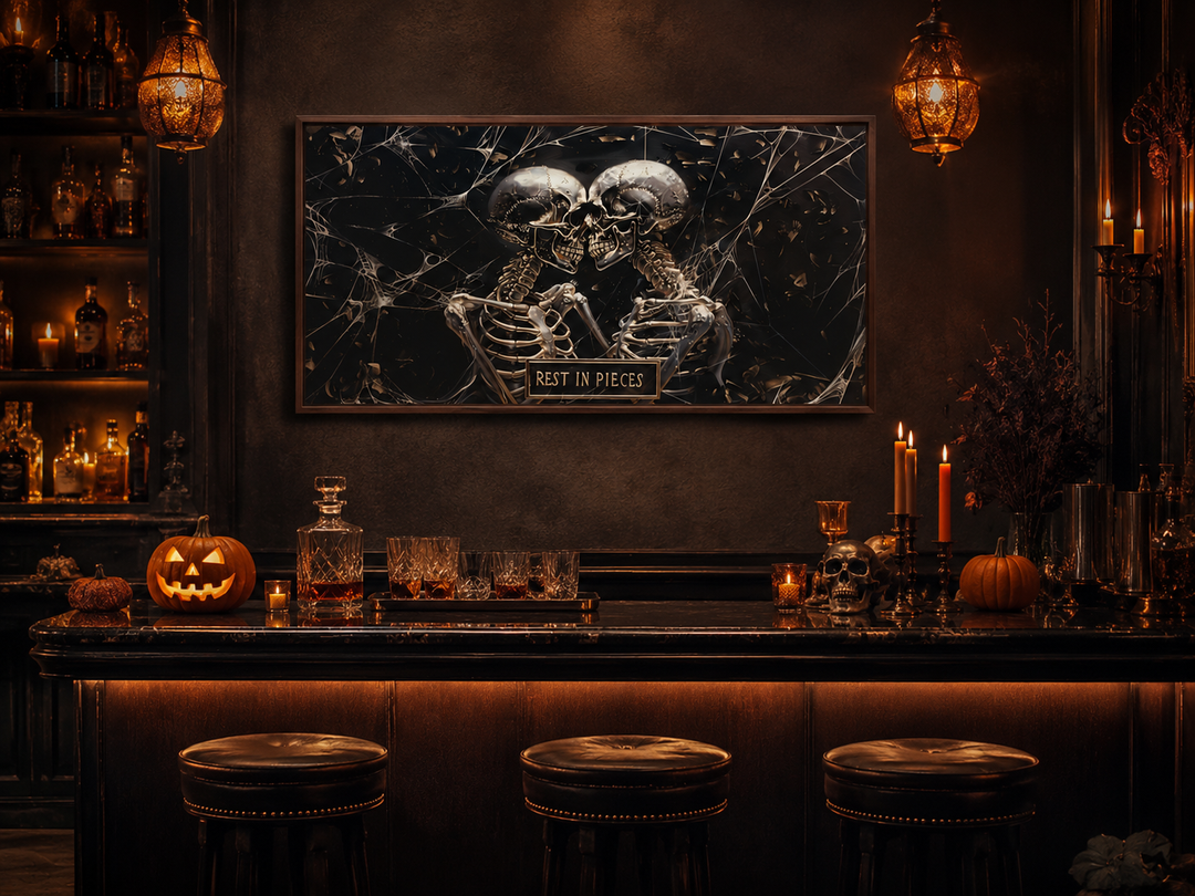 Framed gothic wall art of two skeletons with a "Rest In Pieces" plaque above a Halloween bar setup.