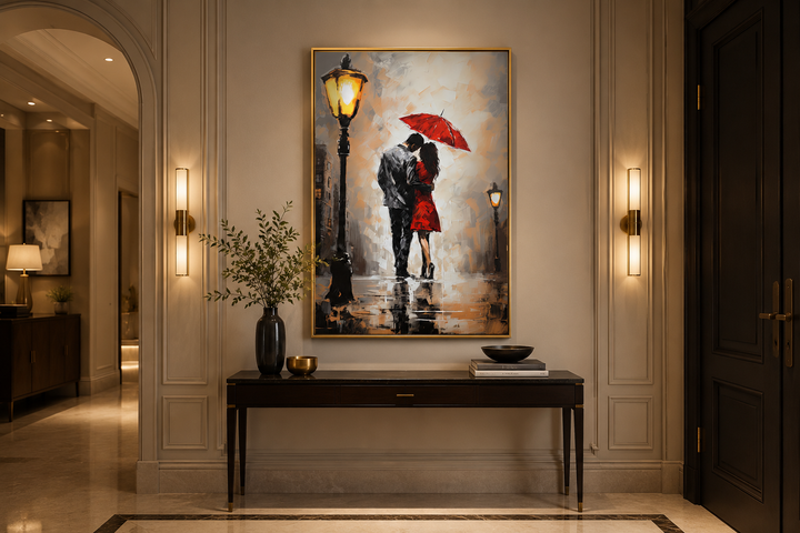 Framed canvas wall art of a couple under a red umbrella in the rain, hung above a console table.