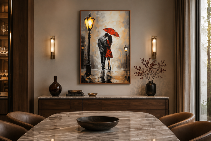 Romantic framed canvas wall art of a couple under a red umbrella in the rain above a sideboard.