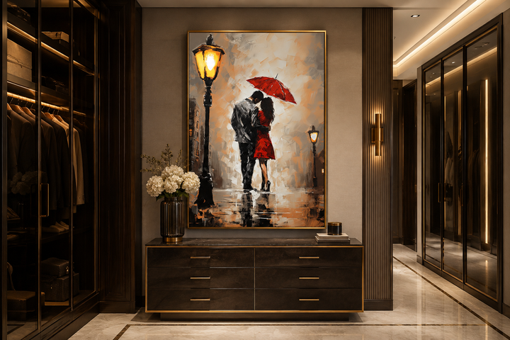Romantic framed canvas wall art of a couple under a red umbrella in the rain above a dark dresser.
