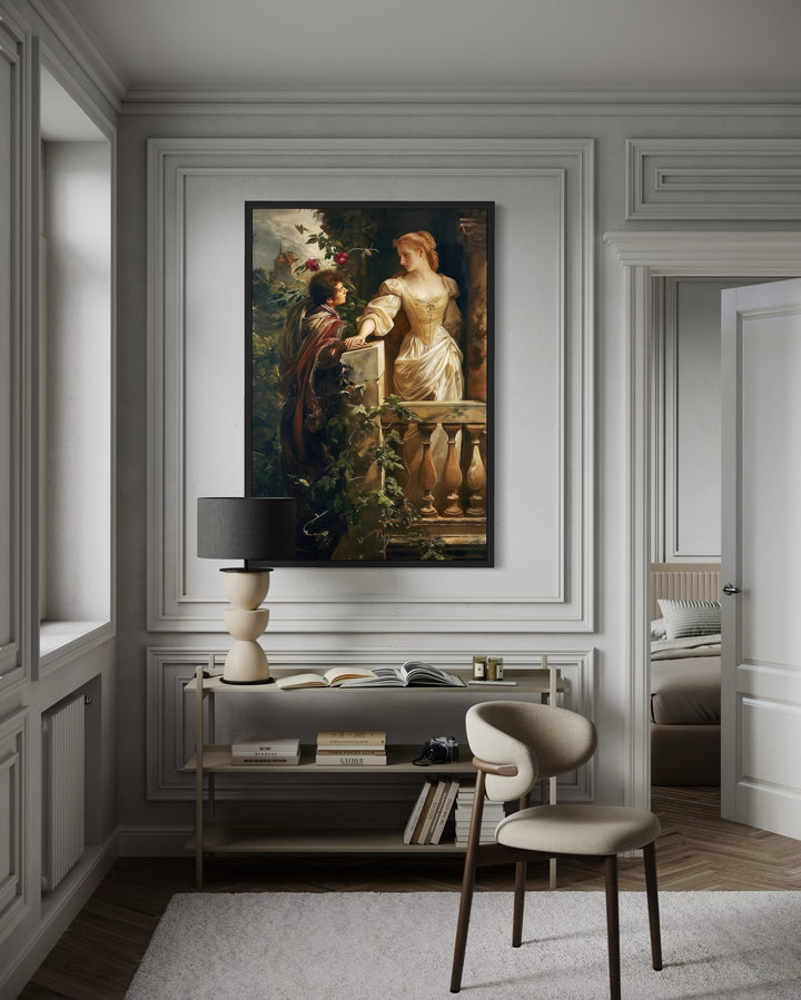 Romeo and Juliet balcony scene vintage painting in a black frame on a white paneled wall.