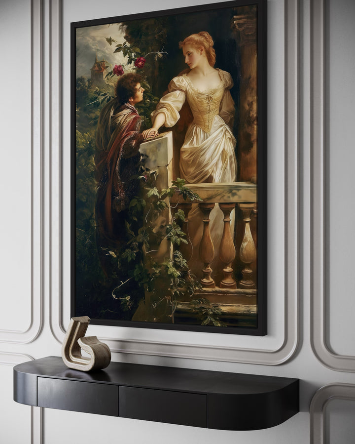Romeo and Juliet balcony scene vintage painting in a black frame above a dark console table.