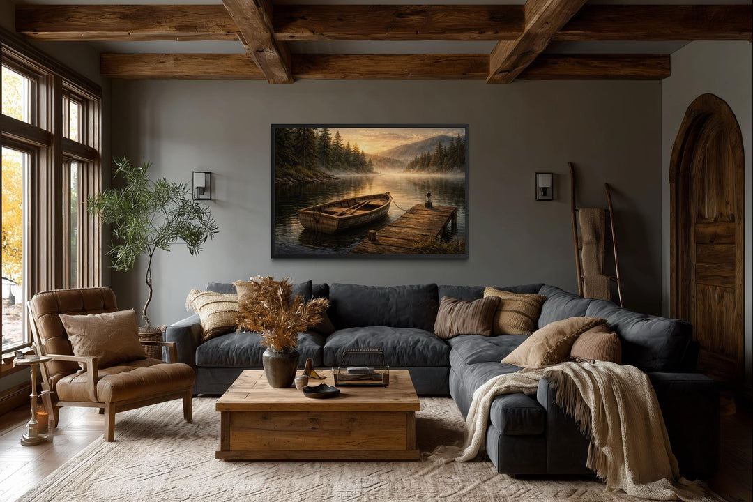 A rustic canvas painting of a rowboat at a peaceful lake dock hangs in a cozy, wood-beamed room.
