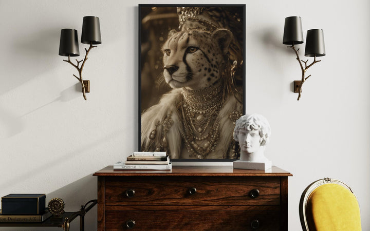 Framed canvas wall art of a cheetah in royal attire and jewelry above a vintage wooden dresser.