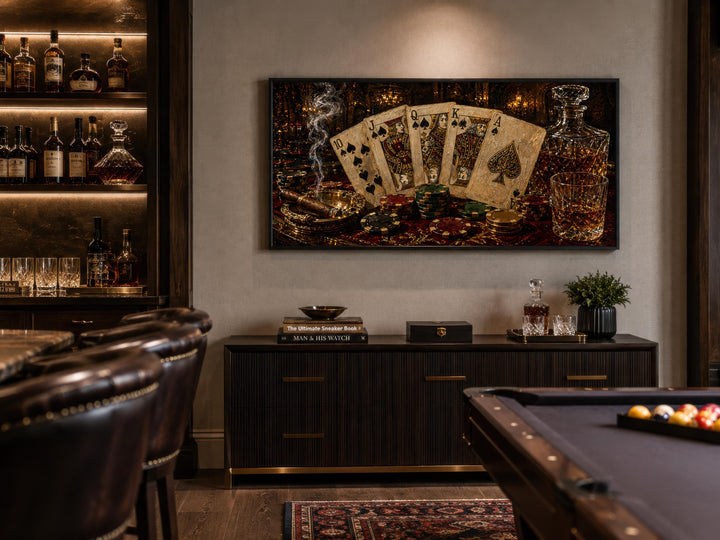 Royal Flush poker canvas wall art displayed above a dark sideboard in a game room with a pool table.
