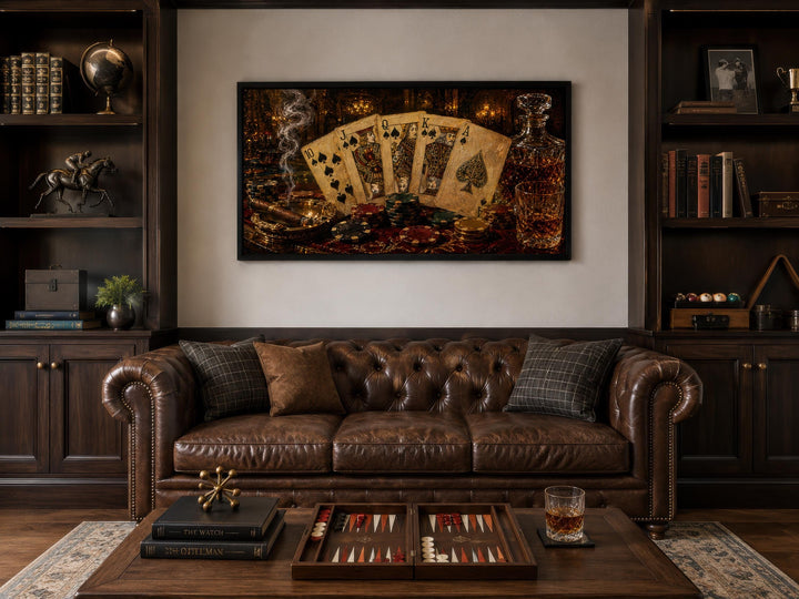 Royal Flush Poker Canvas Wall Art above a brown leather sofa in a dark wood-paneled room.