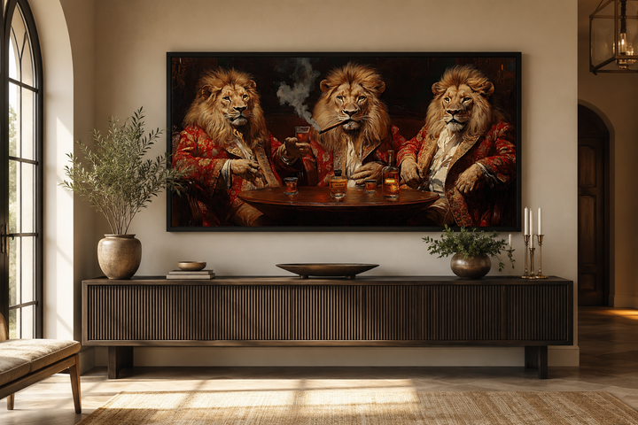 Framed canvas art of three lions in royal attire drinking whiskey and smoking cigars above a buffet.