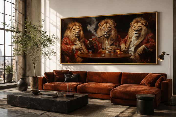Framed canvas art of three lions in royal attire drinking whiskey and smoking cigars above a sofa.