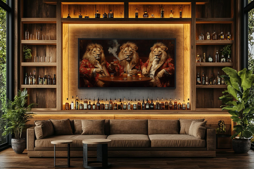 Framed canvas art of three royal lions drinking whiskey and smoking cigars above a bar sofa.