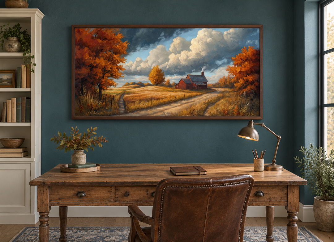 Rustic autumn barn landscape wall art in a dark teal study above a wooden desk.