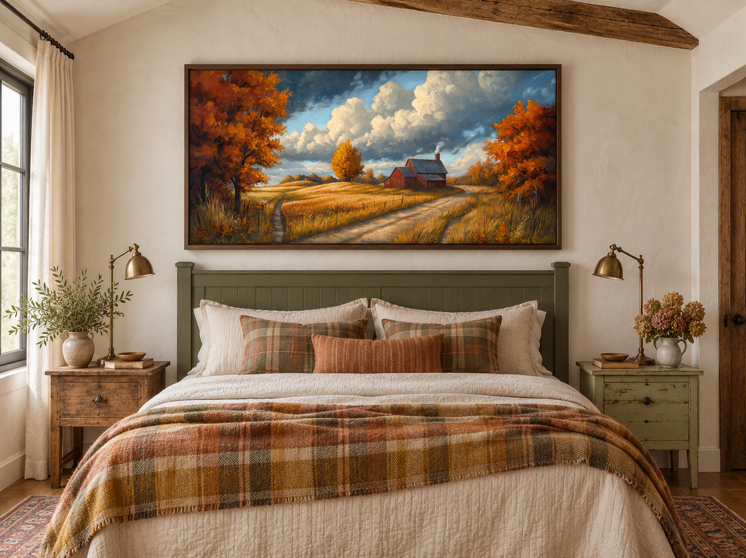 Rustic autumn barn landscape wall art in a walnut frame above a cozy farmhouse bed.